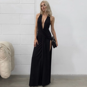 Detail of deep V-neck and ruched halter back on a black high-slit knit maxi dress