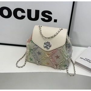 Detail of star pattern denim backpack with white flap and floral metal twist lock