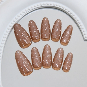 Retro champagne cat eye press-on nails with white polka dots in a long almond shape