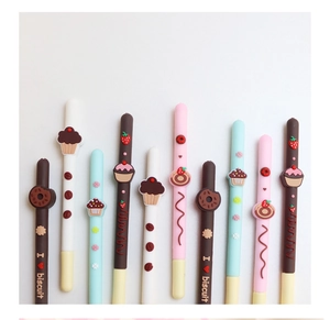 Close-up of assorted cookie stick gel pens with colorful 3D dessert charms on top