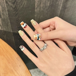 Handmade 3D cartoon bear press-on nails and floral silver ring set on hands