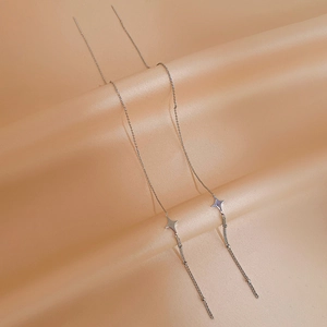 Elegant silver four-pointed star long tassel chain earrings on a soft silk background