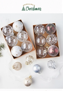 Detail of assorted Christmas balls with glitter and snowflake patterns in a paper box