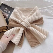 Detailed view of bicolor knit neck warmer with ribbed texture and bowtie cross design
