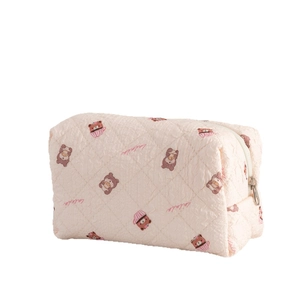 Pink quilted makeup bag with cute cartoon bear and cupcake prints for travel storage