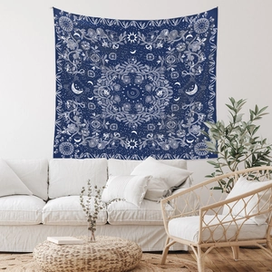 Detail of bohemian tapestry featuring sun, moon, and floral prints in a bright living room