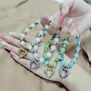 Detailed set of four beaded heart bracelets with cat eye stones and metal spacers