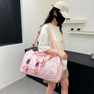 Detail of pink holographic fitness bag with adjustable straps and front zip pocket