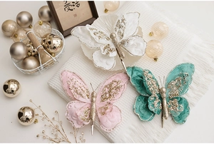 Close-up of glitter fabric butterfly ornaments with gold accents and metal clips
