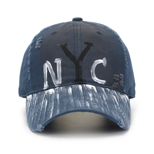 Distressed navy cotton baseball cap with NYC graffiti lettering and paint splatter