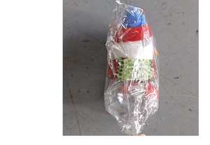 Detail of Christmas snowman candy jar with red hat and scarf in clear packaging