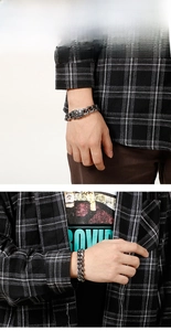 Detail view of vintage men's stainless steel curb chain bracelet with relief clasp