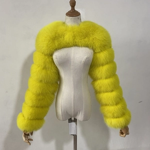 Detail of a bright yellow faux fox fur short shawl with a tiered horizontal stitch design