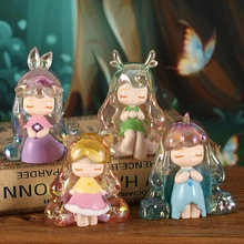 Detailed view of four colorful forest fairy figurines with iridescent translucent hair