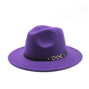 Detail of purple fedora hat featuring black leather band and triple gold chain links