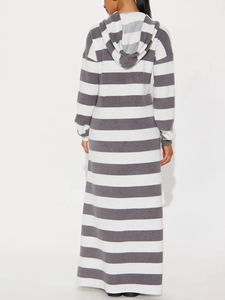 Long grey and white striped hooded dress with a loose fit and long sleeves, back view