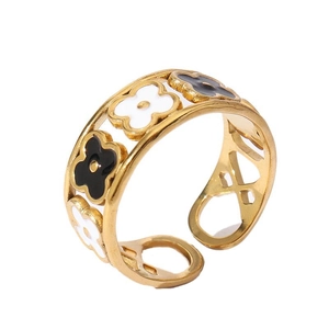 Detailed view of 18k gold plated ring featuring black and white enamel flower patterns