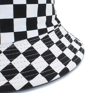 Detailed close-up of the black and white checkerboard pattern on the bucket hat fabric