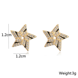 Detail showing 1.2cm x 1.2cm gold plated star earrings with black enamel and zircon