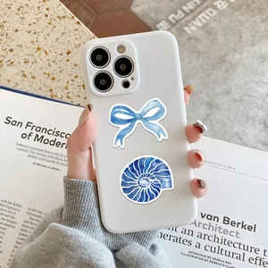 Detail of white matte iPhone case with hand-painted blue bows and nautilus pattern