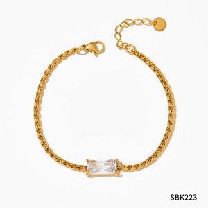 Detail of gold stainless steel chain bracelet with a rectangular zircon and lobster clasp