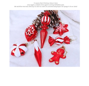 Close-up of red and white assorted Christmas tree ornaments with festive pine cones
