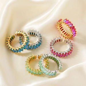 7-piece set of hip hop colorful gemstone rings in gold and silver finish on silk background