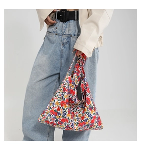 Detail of the colorful floral pattern on a high-capacity canvas tote bag