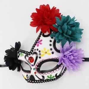 Close-up of Day of the Dead mask with colorful fabric flowers and faux diamonds detail