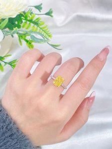 Close-up of yellow emerald-cut high carbon diamond ring on S925 sterling silver band