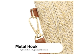 Close-up of durable woven straw texture with brown leather strap and gold metal hook