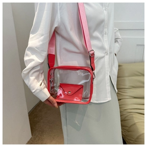 Detail view of red transparent PVC crossbody jelly bag with matching inner pouch on model