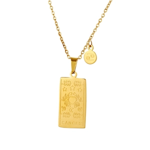 Macro detail of golden Cancer zodiac tarot pendant with intricate crab and celestial motifs