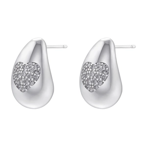 Macro detail of silver drop earrings featuring heart-shaped zircon inlay and metallic luster