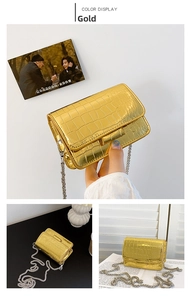 Detail of gold crocodile embossed crossbody bag with metallic silver chain strap