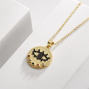 Detailed close-up of golden evil eye pendant with vibrant multicolored zircon stones