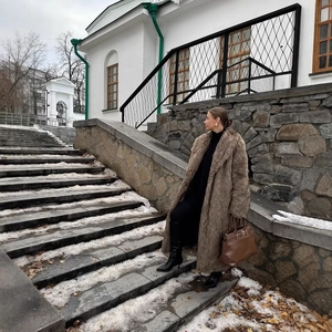 Long faux fur coat in dark brown featuring a notched lapel and thick winter warming design