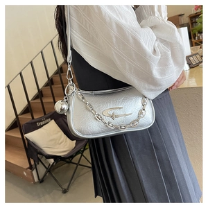 Detail of silver metallic Y2K shoulder bag with star logo and chunky metal chain strap