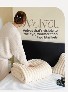 Close-up of thick cream striped flannel blanket featuring soft faux rabbit fur texture