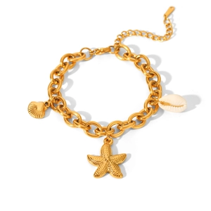 Detailed shot of golden marine bracelet featuring starfish, seashell and conch charms