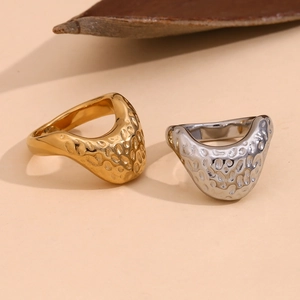 Detail of 18K gold and silver plated stainless steel rings with hammer textured surface