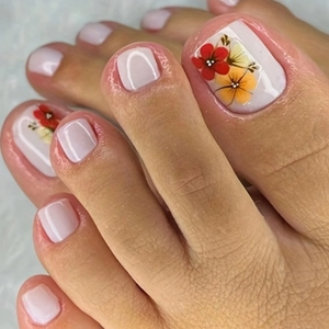 Detailed view of nude press-on toe nails with artistic red and yellow floral patterns