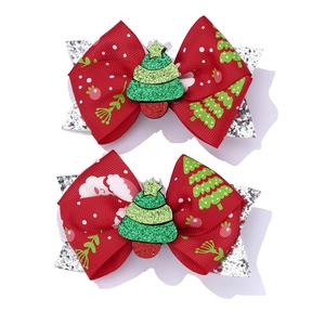 Detail of red Christmas tree bow hair clips with silver sequins and glitter accents