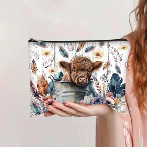 Detail of Highland Cow print on large capacity canvas makeup bag held by hand