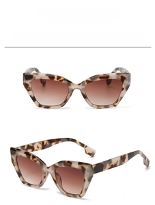 Detail of cat eye sunglasses featuring tortoise shell pattern and brown gradient lenses