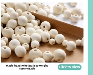 Macro shot of natural round maple wood beads with holes for DIY craft jewelry projects