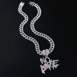 Macro shot of silver Cuban chain with iced out NO LOVE broken heart pendant for men