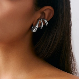 Detail view of silver liquid metal layered ear cuff on model with minimalist geometric design