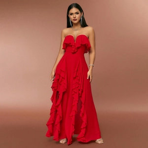 Detail of red strapless maxi dress featuring tiered ruffles and elegant high side slit