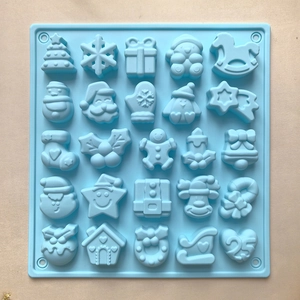 Detailed view of blue silicone mold with 25 diverse Christmas shapes for baking